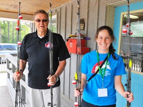 Lawrence Beckett of the Rotary Club of Ingersoll presents a donation of 25 fishing rods to Nicole Wylie, assistant director of programming at Camp Trillium, the camp for kids with cancer outside of Waterford. The camp gets help from service clubs in southwestern Ontario. (DANIEL R. PEARCE Simcoe Reformer)