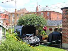 A black Mercedes in the backyard of a home on Earnscliffe Rd. Wednesday, July 1, 2015. The SIU is investigating after the driver died. (Nick Westoll/Toronto Sun)