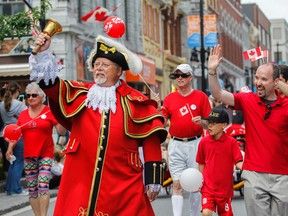 The rain stays away as Kingston's town crier Chris Whyman and Mayor Bryan Paterson lead the Red and White People Parade down Princess Street to City Hall in Kingston, Ont. on Wednesday July 1, 2015. Julia McKay/The Kingston Whig-Standard/Postmedia Network