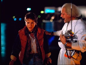 This photo released by Universal Pictures shows, Michael J. Fox, left, as Marty McFly, and Christopher Lloyd as Dr. Emmett Brown, in a scene from the 1985 film, "Back to the Future." Co-stars Lea Thompson, Lloyd and others gather on Tuesday, June 30, 2015, for a special screening of the 1985 Michael J. Fox time-travel blockbuster, to be presented on the massive Hollywood Bowl screen with musical score performed live and orchestra conducted by the original composer, Alan Silvestri. (Universal Pictures via AP)