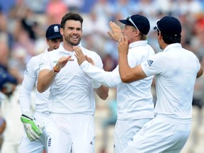 Jimmy Anderson (L) celebrates with his teammates after taking the wicket of India's Shikhar Dhawan during play on the second day of the third cricket Test match between England and India at The Ageas Bowl cricket ground in Southampton. (AFP)
