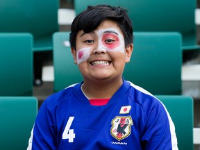 A fan of the Japanese soccer squad is all smiles at Commonwealth Stadium Wednesday. (DAVID BLOOM/Edmonton Sun)