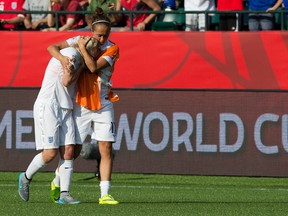 (left to right) England's Josanne Potter (17) consoles Laura Bassett (6) following England's 2-1 lose to Japan during FIFA Women's World Cup Canada 2015 action at Commonwealth Stadium, in Edmonton Alta. on Wednesday July 1, 2015. David Bloom/Edmonton Sun/Postmedia Network