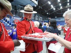RCMP officers helped serve Canada Day cupcakes. Gino Donato/Sudbury Star