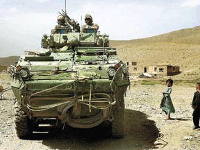 Crew Commander Master Corporal Frederic Ouellet (left) and gunner Corporal Bruno Minier in their LAV III infantry fighting vehicle from C Company 3rd Battalion Royal 22nd Regiment Battalion Group (3 R22eR Bn Gp), stopped on the outskirts of a small village during a patrol in the mountains South of Kabul, Afghanistan in this file photo. The 1st Hussars Association would like to set up an Afghan War memorial in Sarnia made from the shell of a decommissioned LAV III.
Photo: Cpl John Bradley, 3 R22eR Bn Gp