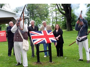 Historical re-enactors, Seamus Gunn, left, and Steve Ferguson, right fire a musket volley Sunday in Port Glasgow at the unveiling of a historical plaque marking the War of 1812. The plaque is one of nine in Elgin county. At the unveiling were,  Joe Preston, Elgin-Middlsex-London MP; West Elgin Mayor Bernie Wiehle; Pete Sheridan, Elgin Historical Society; and Angela Bobier, Backus Page House Museum.