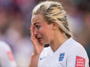 England's Toni Duggan wipes away a tear after her squad's 2-1 loss to Japan in the FIFA Women's World Cup semi-finals at Commonwealth Stadium in Edmonton, Canada on July 1, 2015.  A late own-goal by England defender Laura Bassett put defending champions Japan into the final of the Women's World Cup.    AFP PHOTO / GEOFF ROBINS