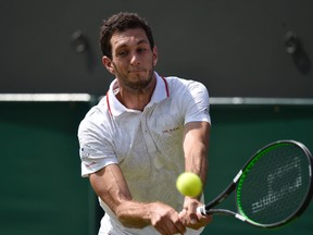 James Ward of Britain hits a shot during his match against Jiri Vesely of the Czech Republic at the Wimbledon Tennis Championships in London, July 2, 2015.            REUTERS/Toby Melville