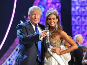 FIn this June 16, 2013, file photo, Donald Trump, left, and Miss Connecticut USA Erin Brady pose onstage after Brady won the 2013 Miss USA pageant in Las Vegas. The Reelz channel said Thursday it will carry Trump's Miss USA pageant that was dropped by NBC after Trump made critical comments about immigrants from Mexico. (AP Photo/Jeff Bottari, File)