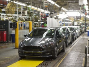 This January 7, 2015 file photo shows a lineup of Ford Focus vehicles on an assembly line at the Ford Michigan Assembly Plant in Wayne, Michigan. AFP PHOTO / SAUL LOEB