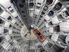 A VW Golf VII car, right, and a VW Passat are loaded in a delivery tower at the plant of German carmaker Volkswagen in Wolfsburg, in this March 3, 2015 file photo. (REUTERS/Fabian Bimmer/Files)
