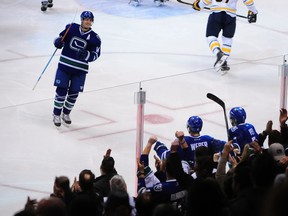 Fans celebrate Vancouver Canucks defenceman Yannick Weber goal against the Buffalo Sabres at Rogers Arena on Jan. 30, 2015. (Anne-Marie Sorvin/USA TODAY Sports)