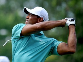 Tiger Woods tees off on the fourth hole during the first round of the Greenbrier Classic golf tournament in White Sulphur Springs, W.Va., on July 2, 2015. (AP Photo/Chris Tilley)