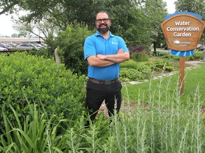 Stephen Sottile, a water conservation officer with Utilities Kingston, stands in the water conservation garden on John Counter Boulevard in Kingston, Ont. on Mon., June 29, 2015. The garden showcases different plants that need less than normal water to flourish. Michael Lea/The Whig-Standard/Postmedia Network