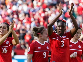 Canada Jonelle Filigno (16), Josée Bélanger (9) and Kadeisha Buchanan (3) salute the crowd after beating China during the second half of a FIFA Women's World Cup 2015 match between Canada and China at Commonwealth Stadium in Edmonton, Alta., on Saturday June 6, 2015. Canada won 1-0. (Ian Kucerak/Edmonton Sun/Postmedia Network)