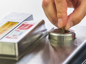 A TTC token is deposited at the entrance to the subway at  Union Station in Toronto, Ont.  on Thursday July 2, 2015. Ernest Doroszuk/Toronto Sun/Postmedia Network