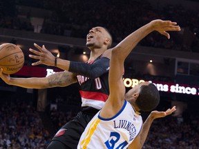 Portland Trail Blazers guard Damian Lillard (0) shoots over Golden State Warriors defender Shaun Livingston during NBA play at Oracle Arena. (Kyle Terada/USA TODAY Sports)