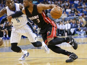 Dwyane Wade is staying with the Heat and will accept a one-year offer to re-sign for $20 million for next season, according to an NBA source. (John Raoux/AP Photo/File)