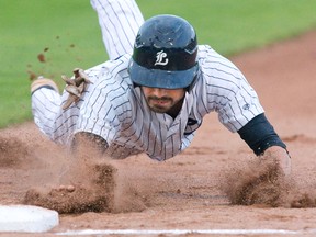 Cody Mombourquette dives to first base to avoid on a pick-off attempt this season. Mombourquette?s base-running has been slowed by a hamstring injury, but his bat and glove are as good as ever. (Free Press file photo)