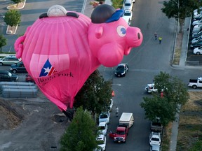 The Bank of American Fork piggy bank balloon crash lands near Utah Valley Regional Medical Center during America's Freedom Festival Balloon Fest on Thursday, July 2, 2015, in Provo, Utah. (Grant Hindsley/The Daily Herald via AP)