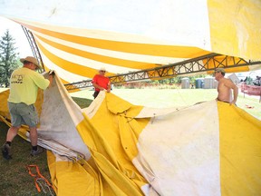 Volunteers work to erect the Canvas Cabaret tent for the Northern Lights Festival Boreal in Bell Park in Sudbury, Ont. on Thursday July 2, 2015. The festival gets underway tonight at 6:30. Gino Donato/Sudbury Star/Postmedia Network