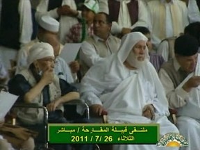 Abdel Baset al-Megrahi (L), who was convicted for the 1988 Lockerbie bombing over Scotland, sits in a wheelchair as he attends a pro-government rally in Tripoli in this still image from a July 26, 2011 video from Libyan state television. The former Libyan intelligence agent, who returned to Libya in 2009 after being freed from a Scottish jail on the grounds he was suffering from terminal prostate cancer, made a rare public appearance on Tuesday at the rally in support of Muammar Gaddafi. REUTERS/Reuters TV via Al Jamahirya