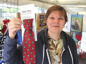 Gale Dillon, from St. Catharines, holds up a dog tie on sale in her booth at Artfest in City Park in Kingston, Ont. on Fri., July 3, 2015. The four-day arts and crafts show wraps up Saturday at 6 p.m. Michael Lea/The Whig-Standard/Postmedia Network