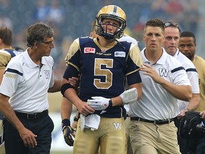 Winnipeg Blue Bombers QB Drew Willy is helped off the field after being injured against the Hamilton Tiger-Cats Thursday night. (Kevin King/Winnipeg Sun)