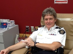 RCMP Supt. Charmaine Bulger donates blood to help launch the Canadian Blood Services Sirens for Life campaign Friday. KEVIN MAIMANN/ EDMONTON SUN