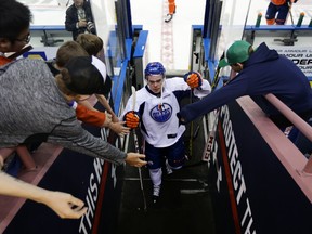 Connor McDavid interacts with fans while leaving the ice after Friday's on-ice session at Rexall Place. (Perry Mah, Edmonton Sun)
