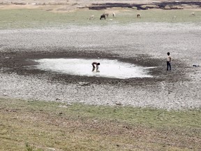 A boy catches fish in a dried-up pond near the banks of the Ganges river in Allahabad, India, in this June 4, 2015 file photo. India's farm economy could contract this fiscal year for the first time in over a decade because of drought, threatening Prime Minister Narendra Modi's drive to lift millions in the countryside out of poverty and bolster his party's support.

REUTERS/Jitendra Prakash/Files