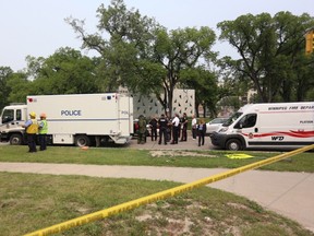 A police tactical team, emergency crews and a bomb unit investigate an explosion at a law firm in Winnipeg. (THE CANADIAN PRESS/Trevor Hagan)