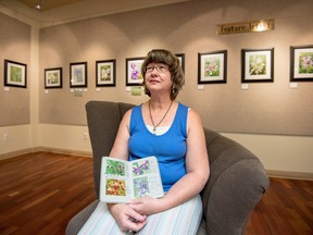 Donna Fillion with her field book at her art exhibit in the Spruce Grove Art Gallery in the Spruce Grove Public Library on Saturday, June 27, 2015. Fillion has documented in large print format some of the flowers she has found at the Nisku Prairie Park Reserve just south of Edmonton. This reserve is special because it is native prairie land, i.e., land that has never been plowed. Fillion’s art exhibit will be on display until July 17. Yasmin Mayne, Reporter/Examiner