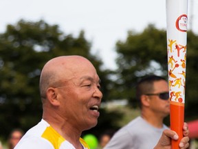 Kenzo Dozono runs the last leg of the Pan Am Games torch relay on Friday July 3, 2015 in Belleville, Ont. Tim Miller/Belleville Intelligencer/Postmedia Network