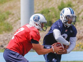 Argos QB Trevor Harris fakes a handoff to Brandon Whitaker during Friday's practice at Downsview Park. (DAVE THOMAS, Toronto Sun)