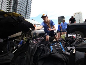Jazz Ward, 15, from the Team Alberta Lacrosse midgets girls team sorts through 120 emergency backpacks filled with summer necessities that include toothbrushes, toothpaste, refillable water bottles, sunscreen, mosquito repellant, hats, and socks to Boyle Street Community Service (BSCS) on Friday, July 3, 2015 in Edmonton, AB. Trevor Robb/Edmonton Sun/Postmedia Network