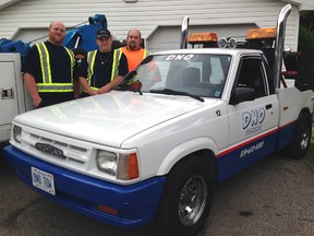 Corbin, left, Don and Cole Neville of DNO Towing proudly show off a long-lost piece of the company's history. The custom Mazda tow truck was built by the company's original owner Norm Dean in 1992 and recently bought by the Neville family.