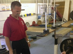 Coach Dan Pare, left, spots David Pigozzo as he trains for the upcoming North American Powerlifting Championships in Moose Jaw, Sask. Pigozzo commutes from Guelph at least once a week to train at Pare's St. Thomas gym.