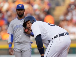 Tigers' Miguel Cabrera grabs his left leg after a steal attempt during the fourth inning as Blue Jays shortstop Jose Reyes looks on during MLB action in Detroit on Friday, July 3, 2015. (Duane Burleson/AP)