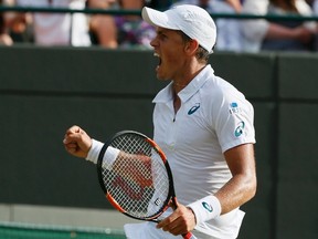 Vasek Pospisil celebrates after breaking serve during his match against James Ward at Wimbledon in London on Saturday, July 4, 2015. (Stefan Wermuth/Reuters)