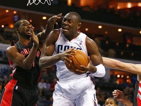 Bismack Biyombo (centre), seen here playing with the Bobcats against the Raptors in November 2012, has reportedly signed with Toronto. (Chris Keane/Reuters/Files)