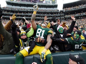 Packers tight end Andrew Quarless celebrates with fans as he does the Lambeau Leap following a touchdown against the Cowboys in the NFC Divisional playoff game in Green Bay, Wis. on Jan. 11, 2015. (Jeff Hanisch/USA TODAY Sports)