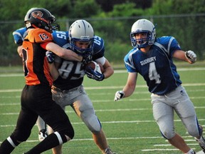 Gladiators' Noah Skuce tries to fight off a tackle by Wolverines' Devin Claypole. Keith Dempsey/For The Sudbury Star
