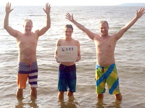 From left, Darren Atchison, Josh Atchison and Derek Atchison celebrate in Lake Superior a week ago, the last swim in their adventure to swim in all five Great Lakes in one day. (CONTRIBUTED PHOTO)
