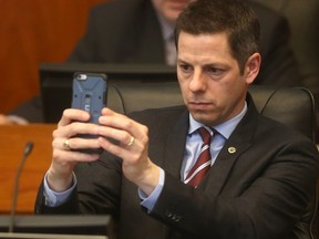 Winnipeg Mayor Brian Bowman uses his phone to shoot photos during a discussion of the city budget at City Hall in March. (Chris Procaylo/Winnipeg Sun)