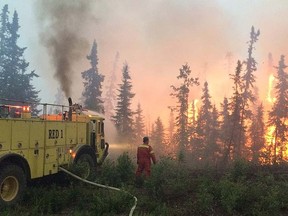 A fire crew battles a blaze in the La Ronge area on northern Saskatchewan, Saturday, July 4, 2016.  THE CANADIAN PRESS/HO/Government of Saskatchewan
