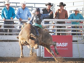 Brian Hervey, from Brant, Alta., hangs onto his bull, Pedro, during the Arrowwood Rodeo and Bull Riding event the evening of June 26. Hervey was the fifth contestant in the lineup, but the first to post a qualifying time. Judges gave Hervey a score of 78.5 for this particular ride.