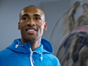 London decathlete Damian Warner, posing in front of a Scott Kish painting of the Pan Am athlete, learned the hard way that failure is part of the sport but that athletes must battle on. (CRAIG GLOVER, The London Free Press)