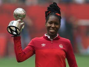 Canada's Kadeisha Buchanan holds up her Best Young Player Award, which was presented after the United States defeated Japan to win the Women's World Cup final in Vancouver on July 5, 2015. (THE CANADIAN PRESS/Darryl Dyck)