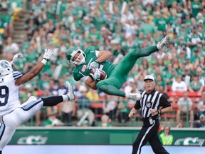 Roughriders' Ryan Smith makes an acrobatic catch against Argos' Matt Black on Sunday in Regina. The Argos, though, tied it in the final seconds, then outscored the Riders 14-12 in overtime for the win. (Mark Taylor, The Canadian Press)